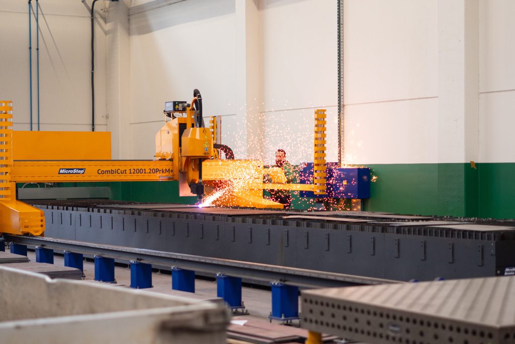 Découpeuse plasma de 13 mètres sur portique MicroStep en train de couper une tôle dans l'atelier du Service Center TRBA